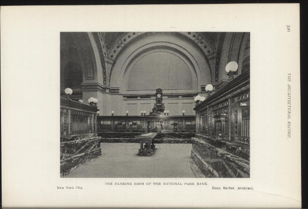Schwarzes und weißes Foto des Banketts des National Park Bank in New York City, das Tische, Lampen, eine Uhr an der Wand und Text am unteren Rand zeigt.