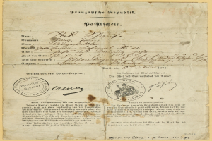 Altes deutsches Regierungsdokument mit einem kreisförmigen, schwarz umrandeten Stempel auf gelbem Papier, das schwarze Schrift enthält.